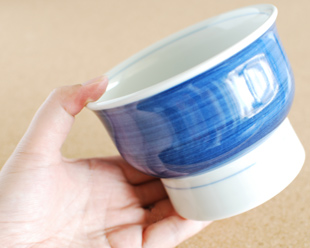 砥部焼・梅山窯　藍色の高台碗を手に持って