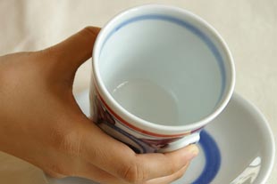 砥部焼　花からくさのコーヒーカップを手に持って