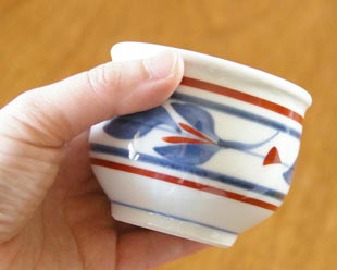 砥部焼・梅山窯　みつ葉の玉ぶち湯呑を手に持って